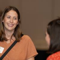 Two guests smile while speaking at their table